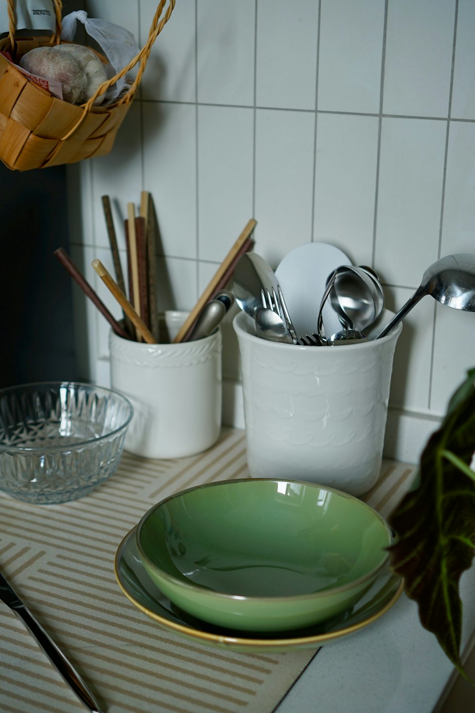 Kitchen utensils and bowls are neatly arranged on a counter.